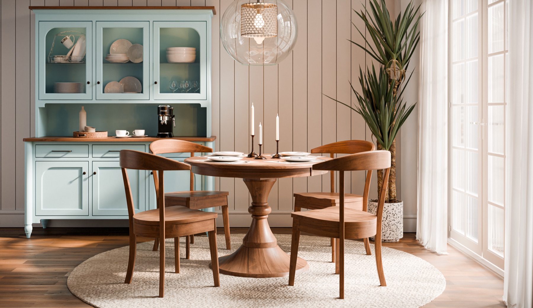 Sunlit dining room with a round wood table, four chairs, and a glass-front hutch.